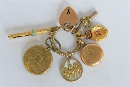 A split ring mounted with numerous gold and other lockets etc. Est. £20 - £30.