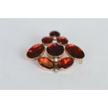 An Antique flat cut garnet brooch set in gold. Est. £25 - £30.