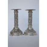 A good pair of Indian candlesticks decorated with palm trees and animals. Approx 260 grams. Est. £
