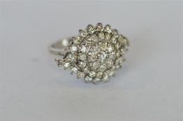 A good quality modern circular diamond cluster ring set in white gold. Est. £250 - £300.