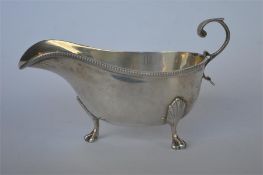A small sauce boat with beaded decoration and scroll handle. Sheffield. By HW & Co. Approx. 100