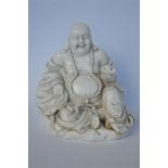 An Oriental Blanc - de - chine Buddha. Approx. 15 cms high. Est. £30 - £40.