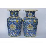 A pair of attractive Persian designed pottery vases. Approx 25 cms high. Est. £30 - £40.