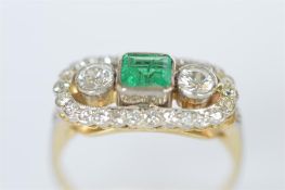 An attractive Art Deco emerald and diamond three stone ring with diamond border in 18ct setting.