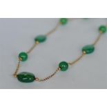 An attractive green stone guard chain with 9ct links. Approx 23 grams. Est. £200 - £250.