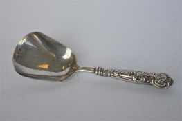 A small caddy scoop with shell decorated handle. Birmingham. By IT. Est. £20 - £30.