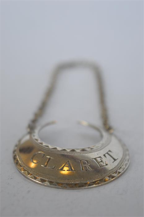 A Hester Bateman crescent shaped claret wine label on suspension chain. Est. £250 - £300.