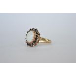 An opal and sapphire oval cluster ring. Approx 3.4 grams. Est. £20 - £30.