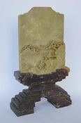 A Chinese soapstone table screen and stand depicting Oriental scene. Approx 30 cms high. Est. £