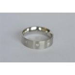 A good quality platinum band nine stone ring. Est. £380 - £420.