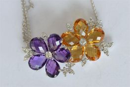 A good quality 18ct amethyst and diamond necklace set with citrine flower on white gold chain.