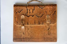 A large snakeskin briefcase with overlap. Approx 39 cms x 35 cms. Est. £30 - £40.