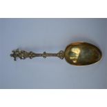 A Continental silver gilt spoon set with man and dog. Est. £20 - £30.