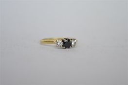 A good small sapphire and diamond three stone ring in 18 ct claw mount. Est. £60 - £70.