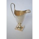 A good quality helmet shaped cream jug with beaded rim, on square pedestal base. London mod. By C&V.