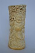 A Chinese well carved bone / horn brush pot decorated with dragons and a Buddha. Est. £50 - £60.