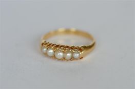 A pearl half hoop ring in gold. Est. £60 - £70.
