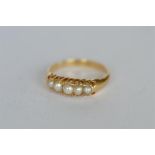 A pearl half hoop ring in gold. Est. £60 - £70.