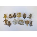 A 7th Dragoon Guard's badge together with various others. Est. £30 - £40.