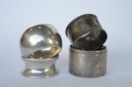 A group of four various engine turned napkin rings. Approx 70 grams. Est. £15 - £20.