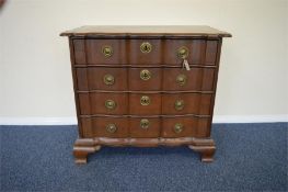 A Continental oak four drawer chest with serpentine front and brass handles. Est. £500 - £600.