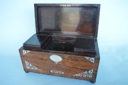 A good rosewood inlaid tea caddy on ball feet and fitted interior. Est. £50 - £60.