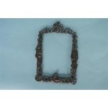 An attractive cast picture frame mounted amongst figures and foliage. London 1889. Est. £100 - £