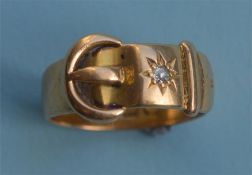 An 18ct gold Victorian buckle shaped ring set with single diamond. Est. £130 - £150.