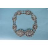 A good quality cherub decorated eight panel buckle belt with scroll decoration. Birmingham 1903.