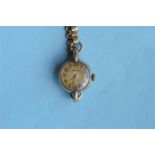 A lady's 9ct Movado wristwatch on gilt strap. Est. £20 - £30.