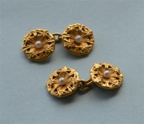 A pair of heavy high carat lily leaf cufflinks with central pearl. Est. £300 - £350.