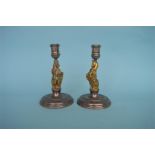 A pair of unusual modern silver candlesticks with silver gilt rampart lion engraved with the Queen's