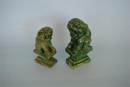 Two good green glazed Chinese dogs. Est. £100 - £120.