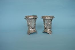 A pair of good Continental vases heavily decorated with figures and scrolls on bracket feet. Approx.