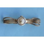 A lady's 9ct Omega wristwatch on gold mesh bracelet. Approx. 23 grams. Est. £160 - £180.