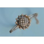 A good quality Victorian 15ct hinged bangle mounted with diamond and pearl bombe centre with