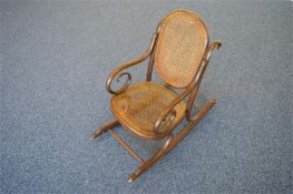 A small child's bentwood rocking chair. Est. £20 - £30.