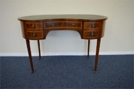 A good quality kidney shaped writing desk with cross banded decoration, tapered supports with