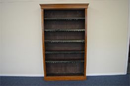 A large burr walnut bookcase with 5 shelves. Approx. 200 cms tall. Est. £100 - £150.