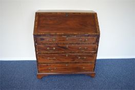 A George II mahogany bureau with cross banded decoration and brass handles with fitted interior.