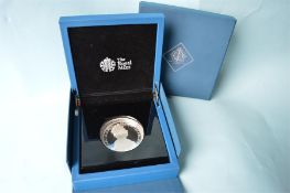 A boxed The Royal Mint £10 five ounce coin, in box with paperwork.