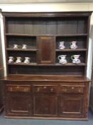 A good Antique elm dresser with cupboard base, shelved top to dental frieze. Est. £600 - £700.