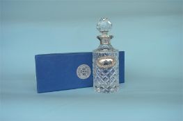 A good quality boxed Millenium hallmark silver mounted decanter with matching label, in fitted