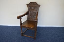 A heavy oak carved hall chair with stretcher base. Est. £30 - £40.