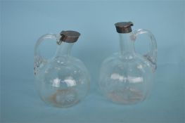 An attractive pair of small decanters with silver rim top. Birmingham 1911. By JM&JHM. Est. £
