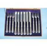 A set of six plus six Albany pattern fruit eaters with silver blades in fitted box. Sheffield
