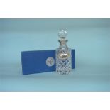 A good quality boxed Millenium hallmark silver mounted decanter with matching label, in fitted