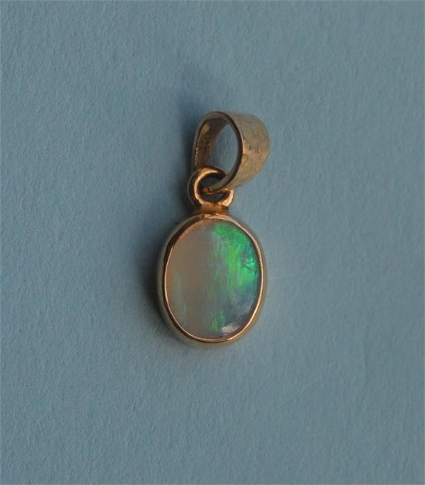 A small opal drop pendant with loop top. Est. £20 - £30.