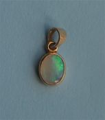 A small opal drop pendant with loop top. Est. £20 - £30.