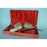 A cased engine turned four piece dressing table set with floral decoration. Birmingham modern. By